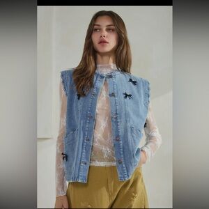 720. Acid washed denim vest with bows and ruffles